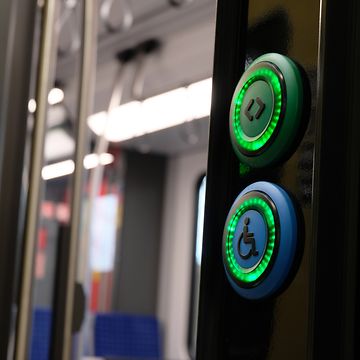 open train door with active, green lighted door opening buttons